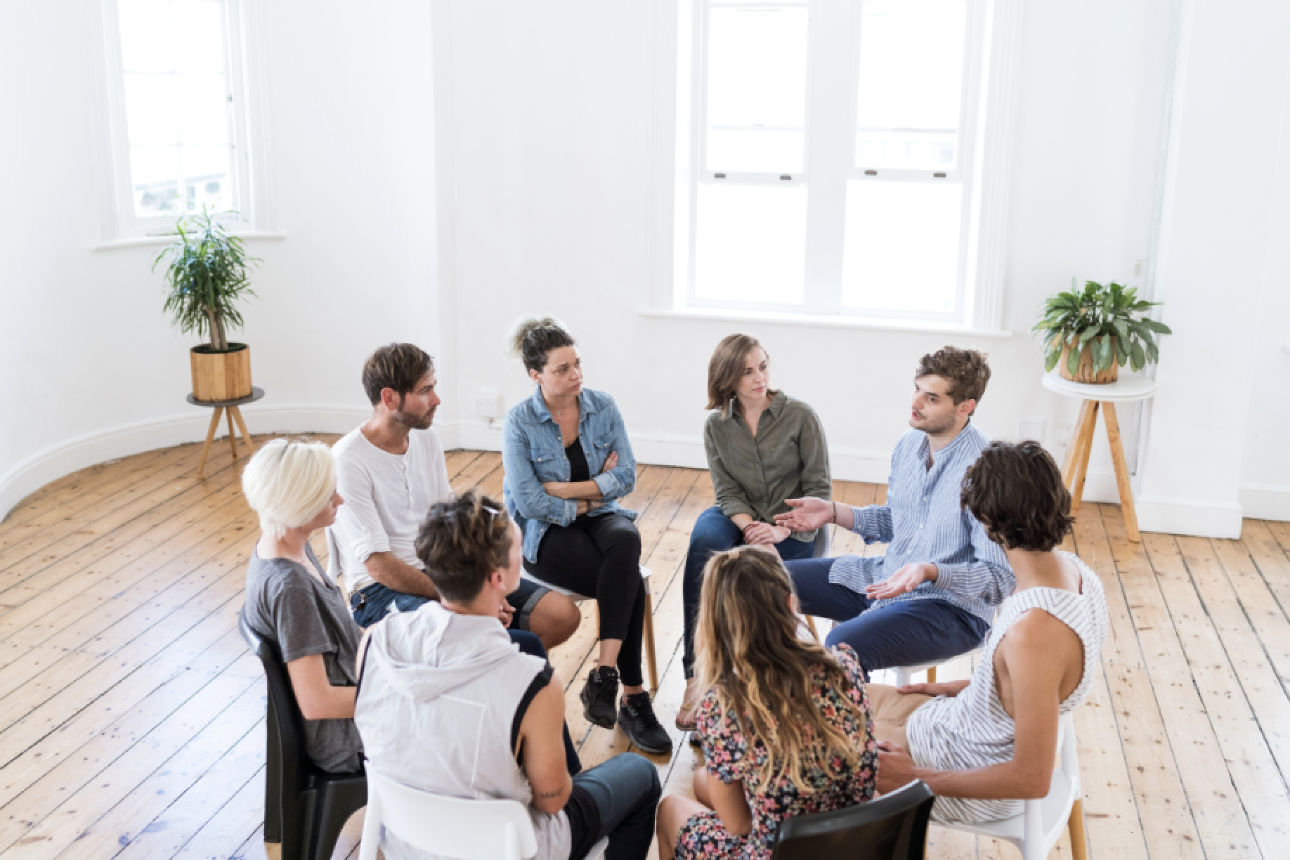 Group of 8 people sitting in a circle.
